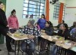 Secretária de Educação, Suelen Cardoso, e a diretora da Escola, Gilciane Baldassari, explicando para as famílias dos alunos a importância do kit escolar